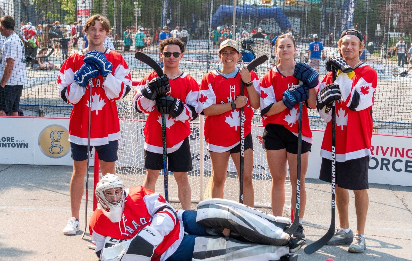 Players celebrate at a Play On! street hockey game